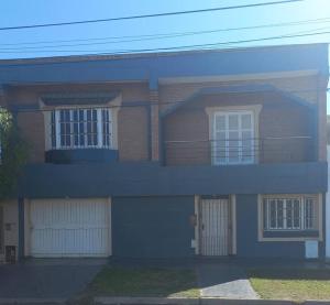 a large brick house with a porch and a balcony at La Casa de Los Mellis.. in La Banda