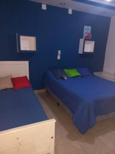 um quarto azul com duas camas num quarto em La Casa de Los Mellis.. em La Banda