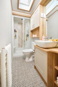 a bathroom with a sink and a toilet at Springwood Holiday Park in Kelso