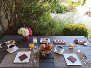 a picnic table with food and drinks on it at Chambres d'hôtes Le Mas de Molines in Vogüé