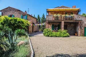 a brick house with a balcony in front of it at Agriturismo Dandelion in Città della Pieve
