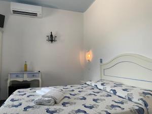 a bedroom with a bed with a blue and white comforter at Turismo Rurale Belvedere Pradonos in Dorgali