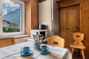 a kitchen with a table with a blender on it at Enrich Apartment in Ortisei