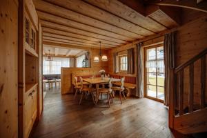 a dining room with a table and chairs in a cabin at Almdorf Reiteralm in Schladming