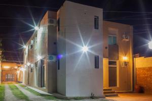 a building with lights on the side of it at night at El Amparo Hotel in San Luis