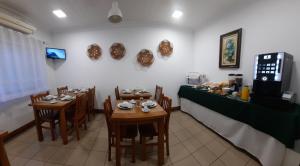 a restaurant with two tables and a counter with food at Hotel Insular in Ponta Delgada