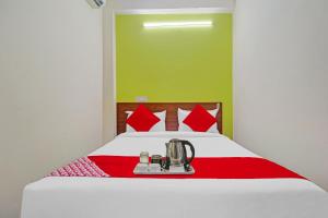 a bedroom with a bed with a blender on it at Hotel Elite Stay Near Habsiguda Metro Station in Hyderabad