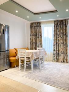 a kitchen with a table and chairs and a couch at Уютен кът in Burgas