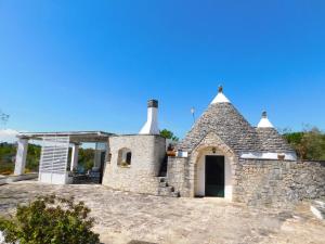 a stone house with a chimney on top of it at Trullo Ada in Ceglie Messapica