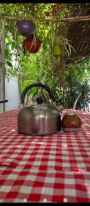 two tea pots sitting on top of a red and white table at Cabaña para disfrutar en cualquier ocasión. in Burzaco