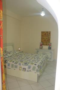 a bedroom with a bed and two dressers at appartement julia au centre ville agadir dans résidence borj dalat in Agadir