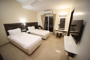 Postel nebo postele na pokoji v ubytování Avenue 11 Premium Stays Madurai