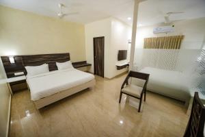 Postel nebo postele na pokoji v ubytování Avenue 11 Premium Stays Madurai