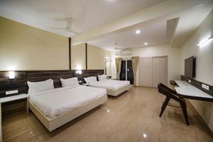 Postel nebo postele na pokoji v ubytování Avenue 11 Premium Stays Madurai