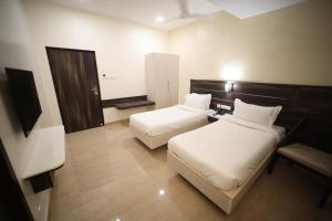 Postel nebo postele na pokoji v ubytování Avenue 11 Premium Stays Madurai