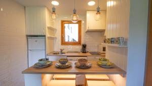 a kitchen with a table with dishes on it at Apartamentos Formigal - Admite mascotas- in Formigal