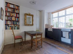 a kitchen with a desk and a table and a mirror at Pass the Keys - Unique historical flat in the hart of London, South Bank in London