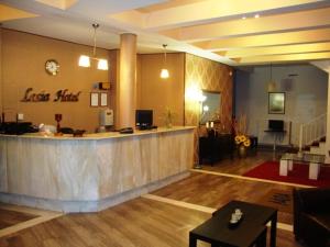 a large lobby with a bar in a restaurant at Lasia Hotel in Mytilene