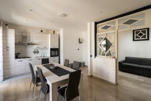 a kitchen and dining room with a table and chairs at Casa Lungomare IX Maggio by Wonderful Italy in Bari