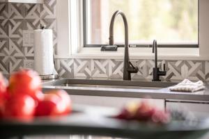 a kitchen counter with a sink and a window at Spanish Peaks Highlands Cabin 59 in Big Sky +46 photos