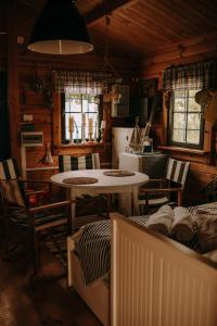 a kitchen with a table and chairs in a room at Freedolina Glamping in Łowyń