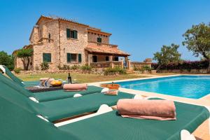 a villa with a pool in front of a house at Villa Els Amatllers by Sealand Villas in Port de Pollensa