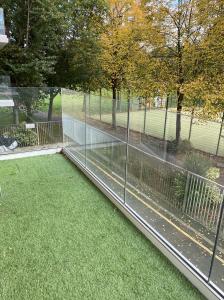 a view of a garden with a fence and grass at Modern and cozy two bed in Clapham 5 in London