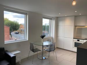 a kitchen with a table and chairs and a window at Modern and cozy two bed in Clapham 5 in London