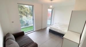 a living room with a couch and a bed at Modern and cozy two bed in Clapham 5 in London