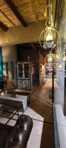a living room with a table and a chandelier at Hotel Tulmas in Tilcara