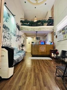 a living room with wooden flooring in a room at Alleyway Hostel in Ho Chi Minh City