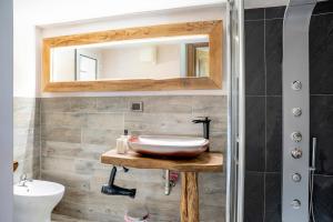 a bathroom with a sink and a mirror at La rosa sul lago in Osiglia