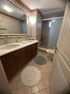 a bathroom with a sink and a toilet and a mirror at SEAmpliCITY cozy apartment in Heraklio Town