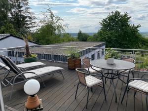 a balcony with a table and chairs on a deck at DreiländerOase in Perl