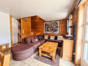 a living room with a couch and a table at Chalet Flaine, 5 pièces, 8 personnes - FR-1-425-123 in Flaine