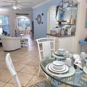 a dining room and living room with a table and chairs at Beach Condo in Clearwater Beach