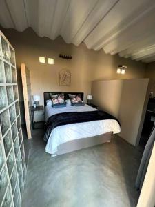 a bedroom with a large bed in a room at The Stables in Roodepoort