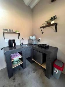 a kitchen with a counter and a sink in a room at The Stables in Roodepoort