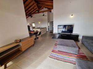 a large living room with a couch and a table at Mansion a Lago in Itauguá