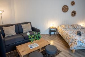 een woonkamer met een bank en een salontafel bij Les Pétrels by Nid'Ouest - Coeur de ville in Quimper