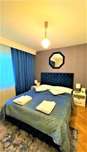 a bedroom with a large bed with towels on it at Arc de Triomphe BlissBoutique in Bucharest
