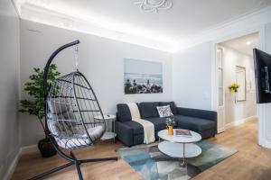 a living room with a blue couch and a table at Tendency Apartments Miro 6 in Barcelona