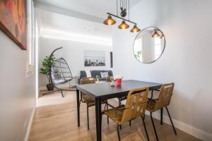 a dining room with a black table and chairs at Tendency Apartments Miro 6 in Barcelona