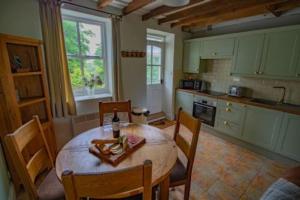 a kitchen with a wooden table and chairs and a table and a table at Moor View in Lockton