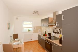 a kitchen with a counter and a table in it at Ferienwohnung Franke in Zinnowitz