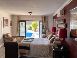a bedroom with a bed and a living room at 2 Op Terblanche Guesthouse in Boksburg
