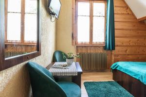 una habitación con una cama, una mesa y sillas en Willa Jasinek, en Zakopane
