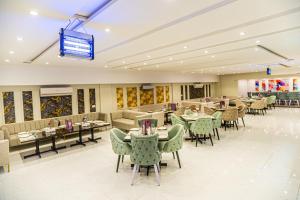 a restaurant with tables and chairs in a room at C Suites in Lahore