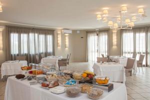 a buffet table with food on it in a restaurant at Hotel Centrale in Sabaudia