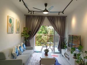 a living room with a couch and a ceiling fan at Dream4 @ emerald avenue in Brinchang
